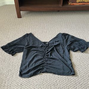 Black, puff-sleeved blouse with drawstring in the middle